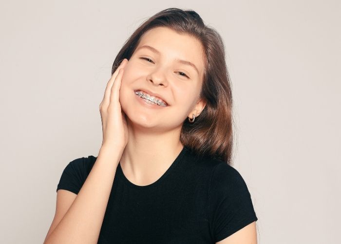 girl smiling wearing metal braces