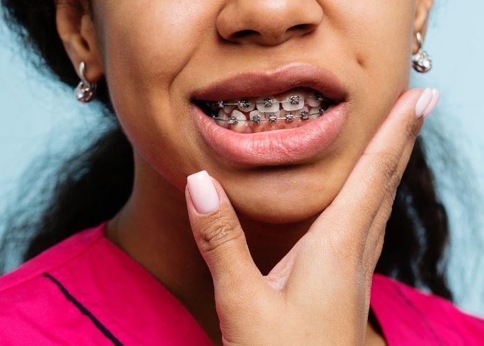 girl experiencing pain from her braces